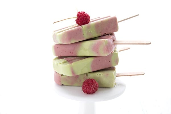 Low Carb Avocado Berry Swirl Pops in a stack on a white plate