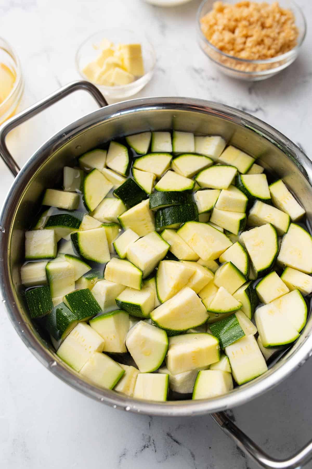 Chopped zucchini in a pot with water. 