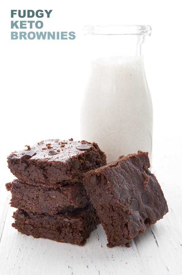 Easy keto brownies in a stack in front of a bottle of milk