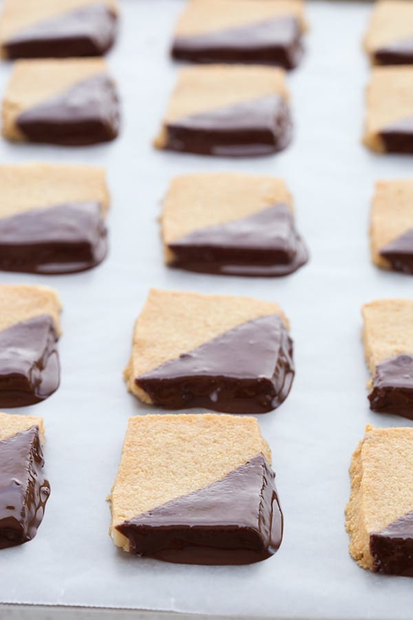 Low carb shortbread dipped in chocolate on a baking tray.