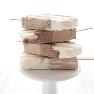 Keto Root Beer Float Popsicles in a stack on a white plate