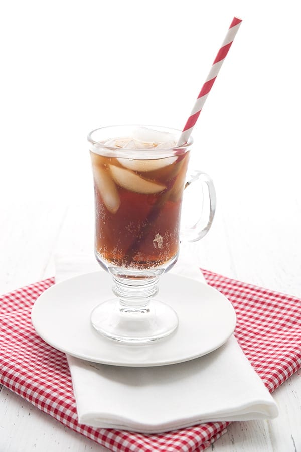 Sugar free root beer in a glass with a striped red straw