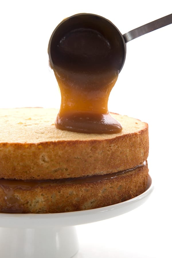Sugar free caramel being poured over low carb vanilla cake