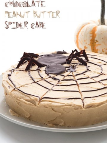 Keto Spider Web Cake on a plate with pumpkins in the background