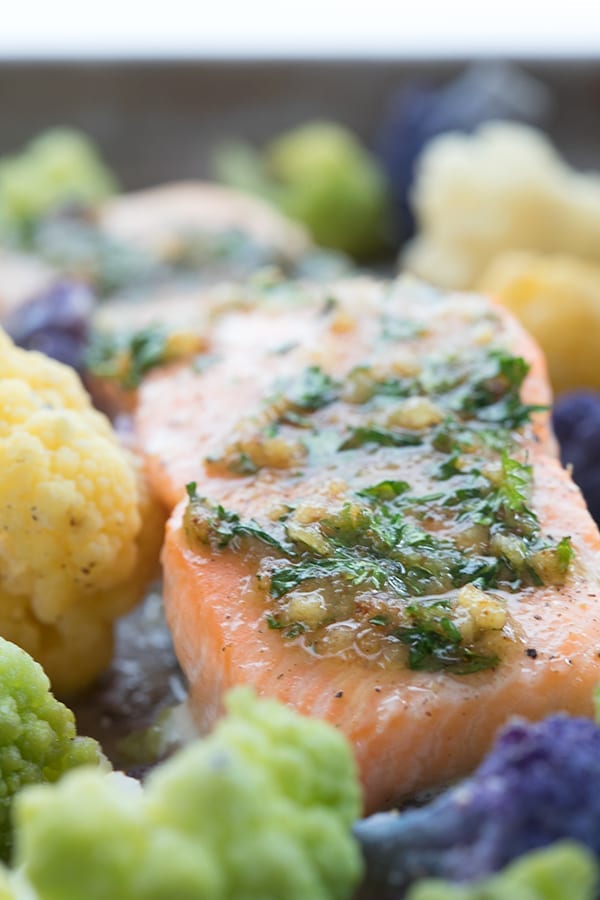 Close up of garlic butter salmon surrounded by cauliflower