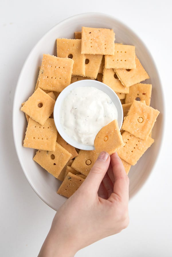 Dipping a keto cheese cracker into ranch dressing