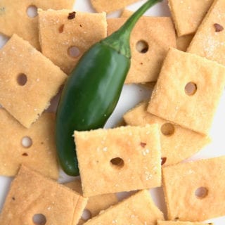 Cheese crackers in a pile with a jalapeño