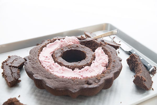 Pink raspberry filling in a chocolate bundt cake