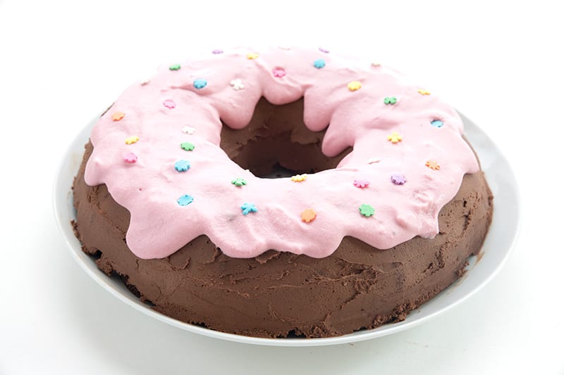 Keto Chocolate Donut Cake on a white cake stand