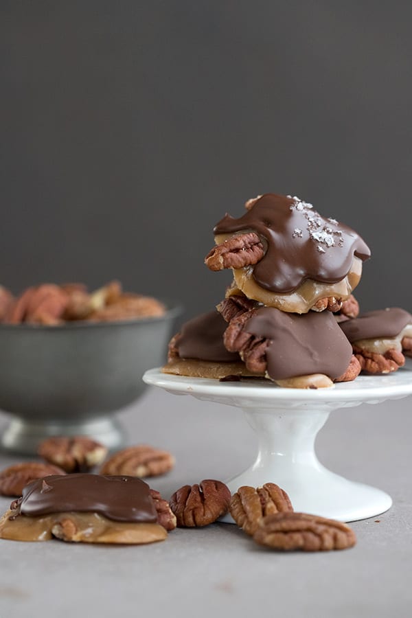 Sugar Free Pecan Turtle Candies on a white cake stand