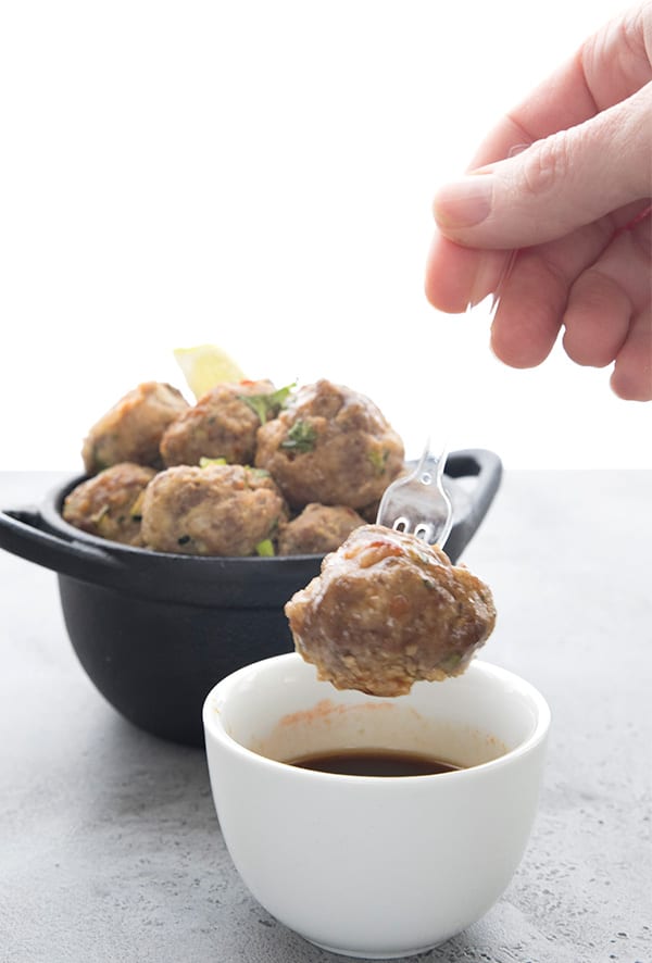 Dipping a Whole 30 pork meatball into Thai dipping sauce