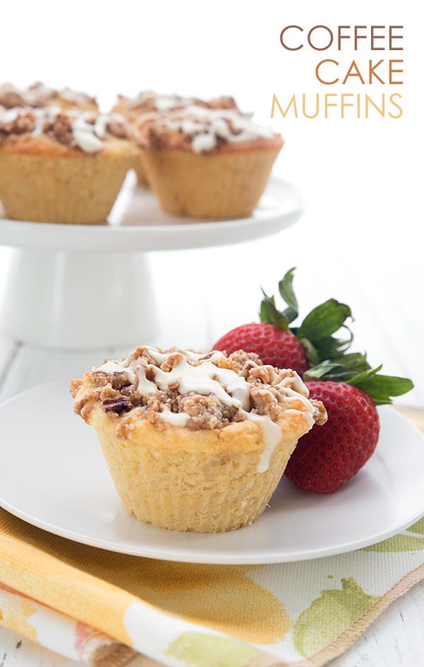 Keto coffee cake muffins on a white plate with strawberries.