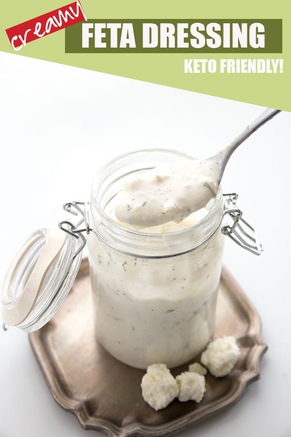 Creamy feta dressing in a jar with a spoon