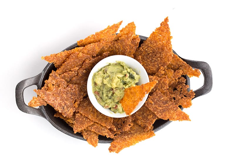 Top down photo of low carb tortilla chips with guacamole