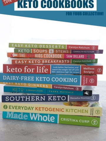 A pile of the best keto cookbooks, spines and titles facing outward