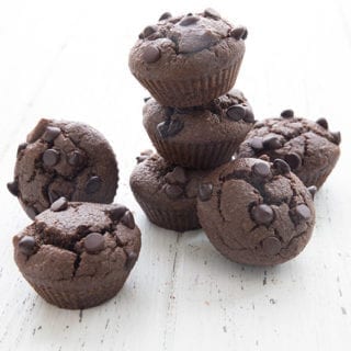 Double chocolate mini muffins in a pile on a white table