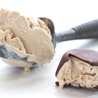 A scoop of coffee ice cream beside a chocolate covered ice cream truffle