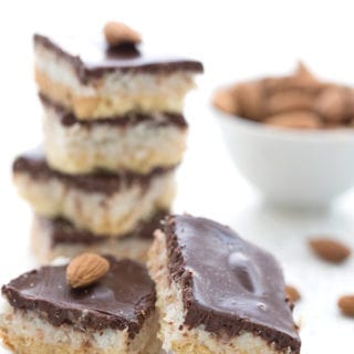 A stack of keto dairy-free Almond Joy Bars on a white table.