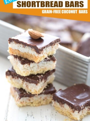 Keto Almond Joy Bars in a stack with the pan of bars in the background