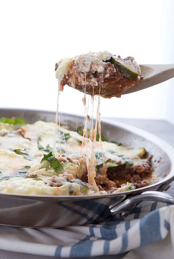 A scoopful of keto skillet lasagna being pulled away from the skillet