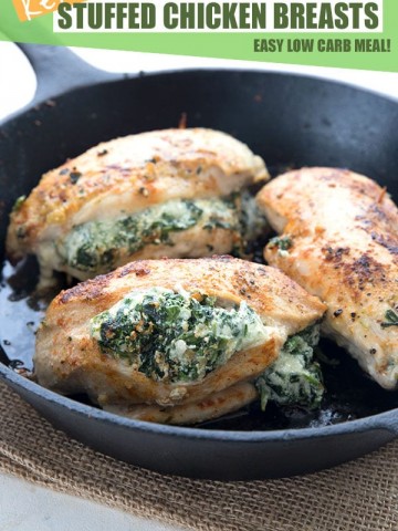 Keto stuffed chicken breasts in a cast iron pan. Stuffed with spinach and cheese.