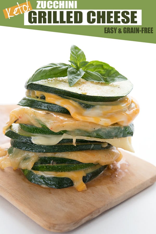 Zucchini grilled cheese sandwiches in a stack on a wooden cutting board