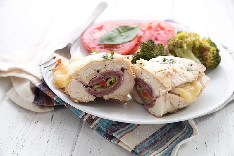 Keto stuffed chicken breast cut in half to show the fillings
