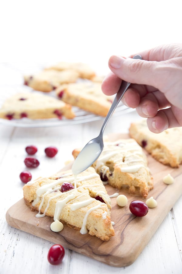 Drizzling white chocolate over keto cranberry scones