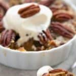 Titled image of a mini Keto Pecan Pie with a spoonful taken out of it.