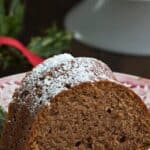 A slice of Keto Gingerbread Pound cake on a red patterned plate with a fork.