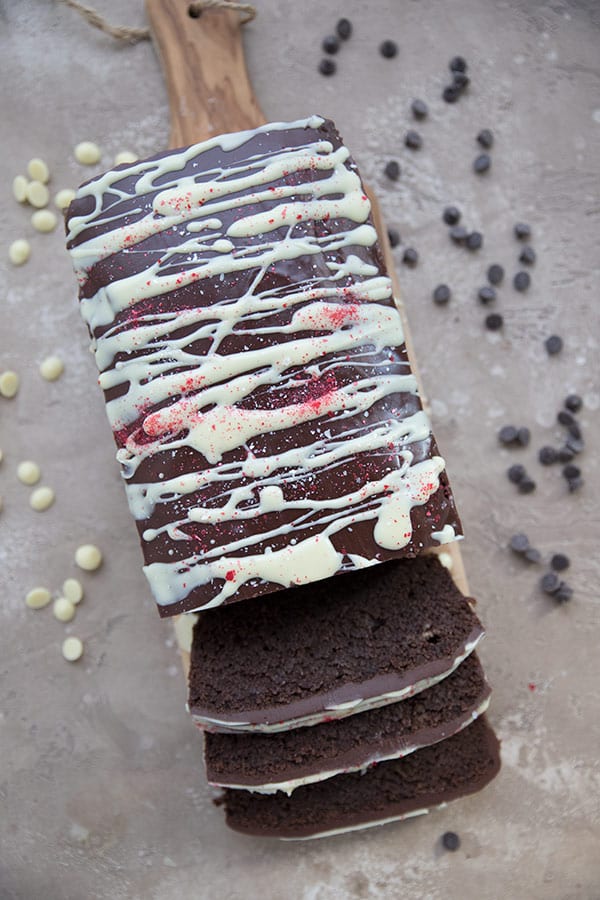 Top down photo of keto chocolate pound cake with chocolate peppermint glaze and white chocolate drizzle.