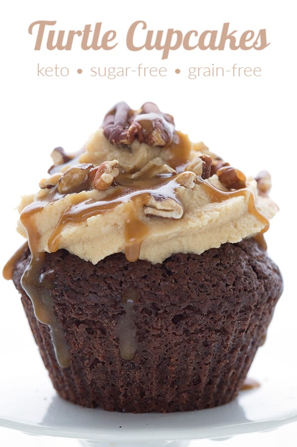 Close up of a keto chocolate cupcake with caramel frosting, toasted pecans, and caramel sauce. 