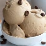 Titled image of a bowl of keto coffee ice cream with coffee beans sprinkled on top.