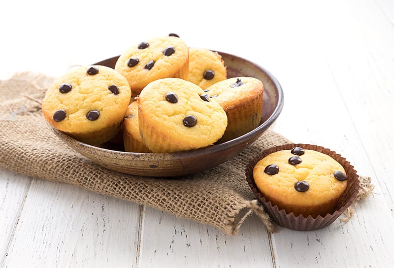 A bowl of banana muffins on a burlap napkin