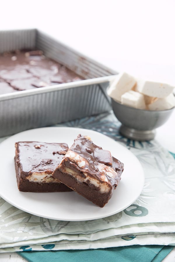 Two Mississippi Mud Bars on a white plate, with the pan of bars in the background