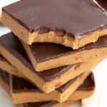 Titled Pinterest image of a stack of Keto Peanut Butter Bars with a bite taken out of the top one.