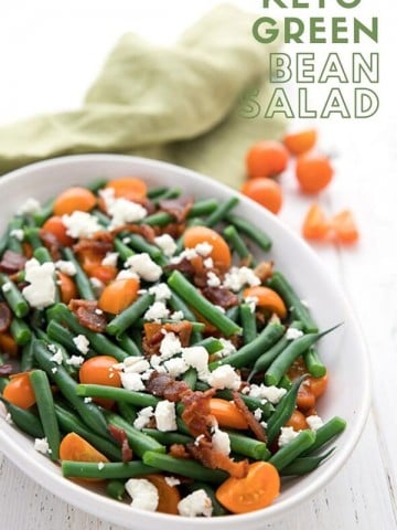 Titled image of Green Bean Salad with bacon, tomatoes and feta in a white oval dish