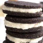 A stack of keto copycat Oreo cookies on a white table.