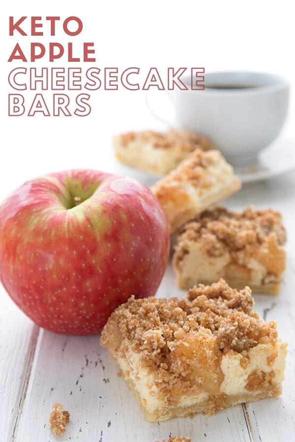 Titled image of keto apple cheesecake bars on a white table with an apple and a cup of coffee