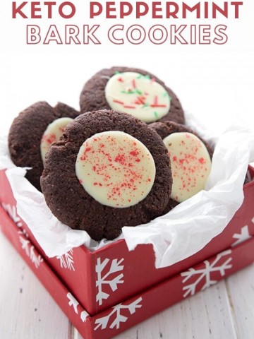 Titled image of keto peppermint bark cookies in a red gift box with white tissue paper