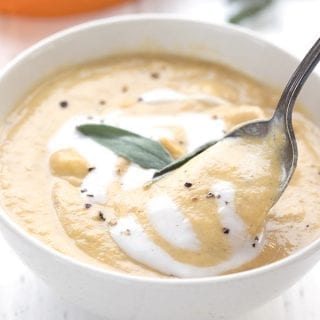 Close up shot of a spoonful being lifted out of a bowl of keto pumpkin soup
