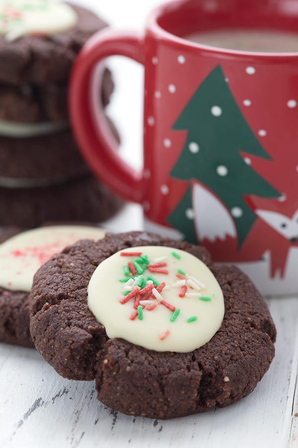 Close up shot of a keto peppermint bark cookie with a cup of coffee in behind.