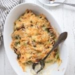 Top down photo of cheesy Brussels Sprouts Casserole in a white oval dish