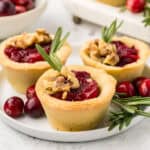 Three Keto Cranberry Brie Bites on a small white plate.