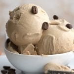 Titled image: A bowl of keto coffee ice cream with coffee beans sprinkled on top.