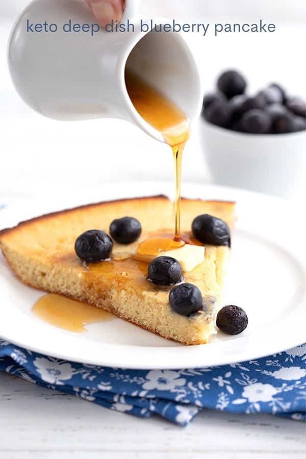 Titled image: Sugar-free pancake syrup pouring over keto blueberry pancakes.