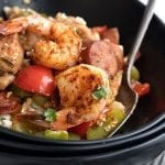 Titled image of keto jambalaya in a black bowl with a fork.
