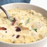 Titled image of a bowl of keto seafood chowder on a white table.