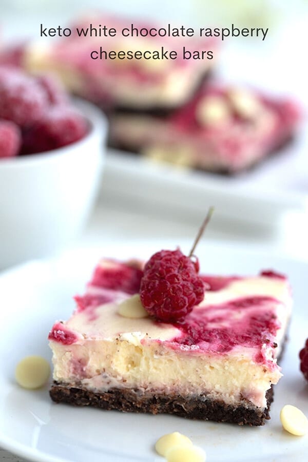 Titled image of keto white chocolate raspberry cheesecake bar on a white plate.