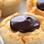 Titled image of Keto Boston Cream Cookie Cups on a white plate.